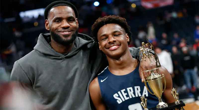 LeBron James poses with his son Bronny after Sierra Canyon beat Akron St. Vincent-St. Mary in a high school game